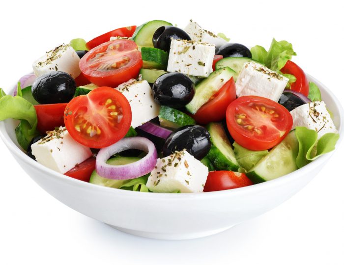 Salad with cheese and fresh vegetables isolated on white background. Greek salad. With clipping path.