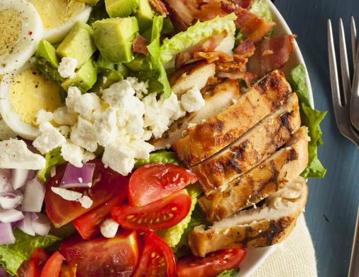 Healthy Hearty Cobb Salad with Chicken Bacon Tomato Onions and Eggs