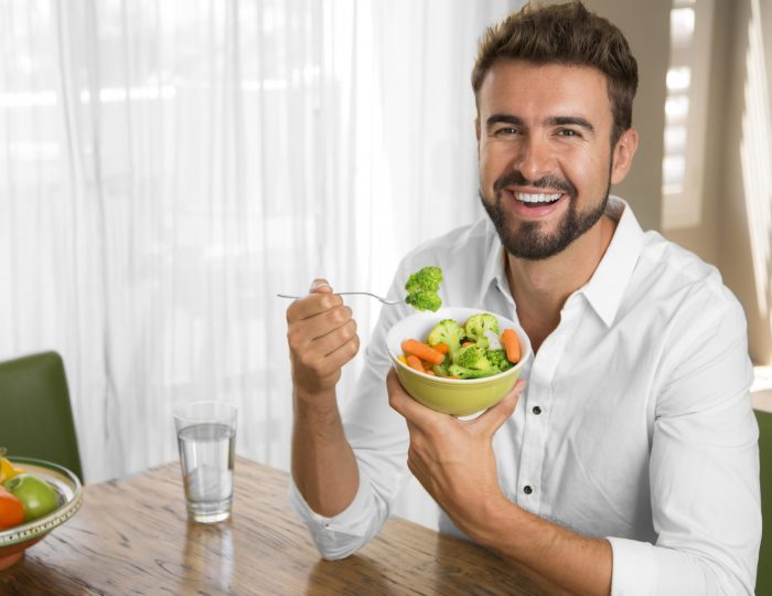 Man with perfect skin eating a healthy meal